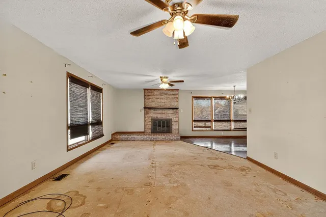 a front view of a house with a garden and trees