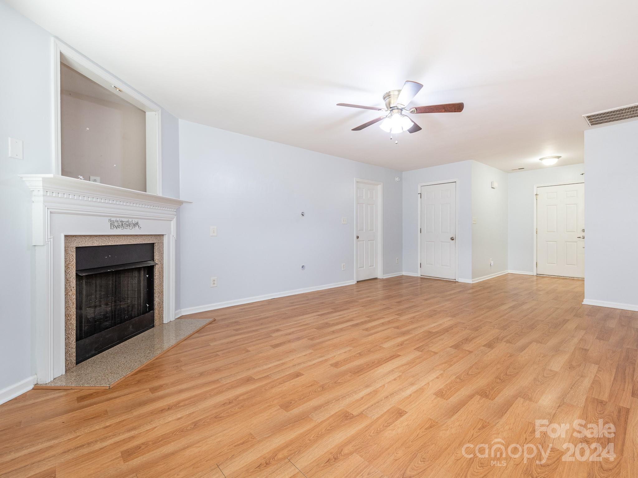 401 Funderburk Road Wingate, NC 28174 - Photo 14 of 36 a view of empty room with fan and kitchen view