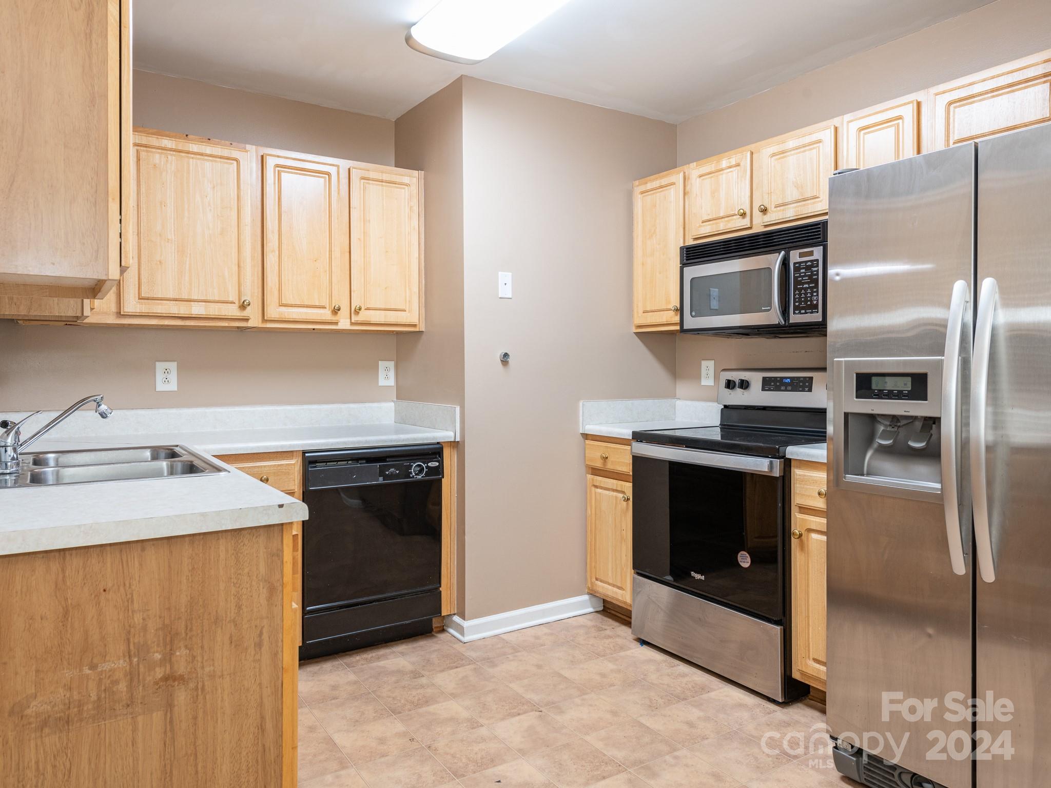 401 Funderburk Road Wingate, NC 28174 - Photo 17 of 36 a kitchen with stainless steel appliances granite countertop a stove a microwave and a refrigerator