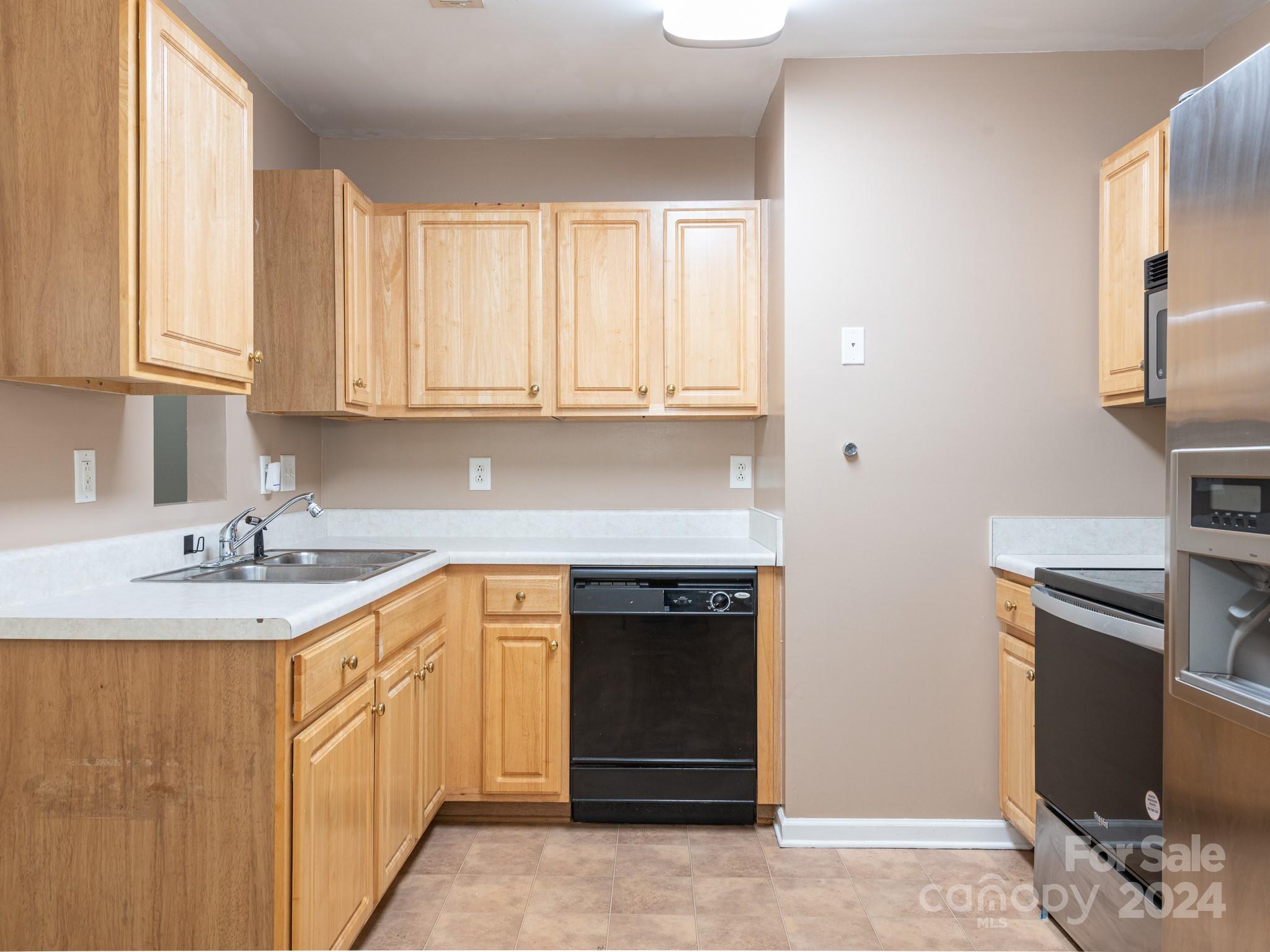 401 Funderburk Road Wingate, NC 28174 - Photo 18 of 36 a kitchen with stainless steel appliances granite countertop a stove a sink and a refrigerator