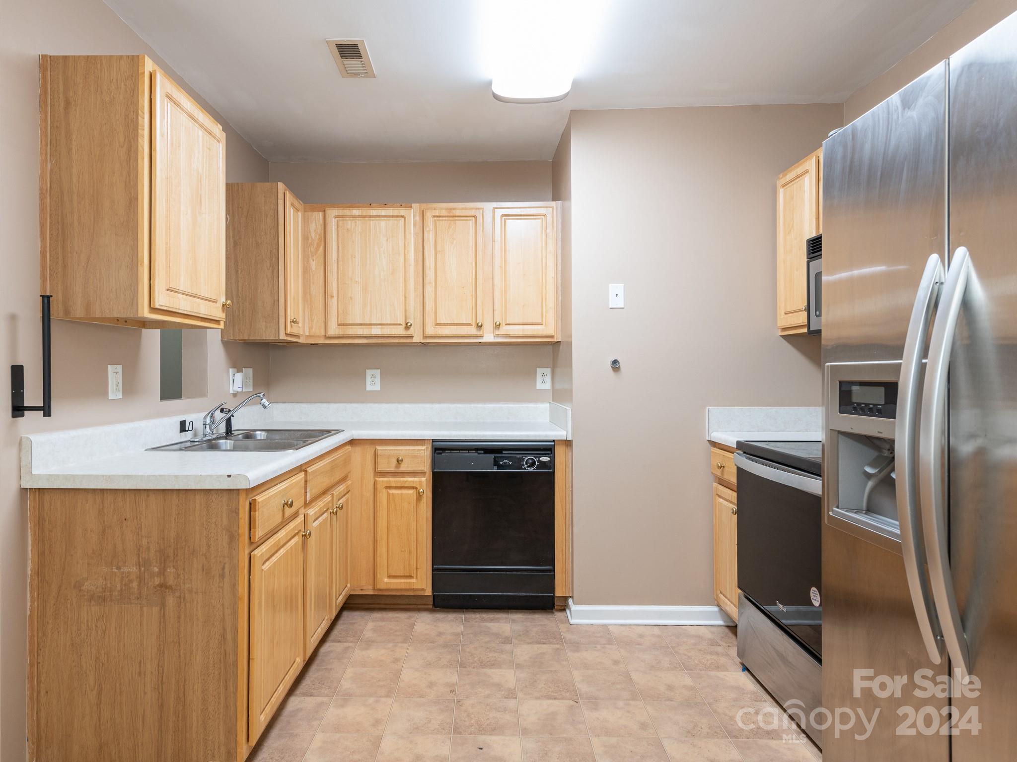 401 Funderburk Road Wingate, NC 28174 - Photo 3 of 36 a kitchen with stainless steel appliances granite countertop a stove a sink and a refrigerator