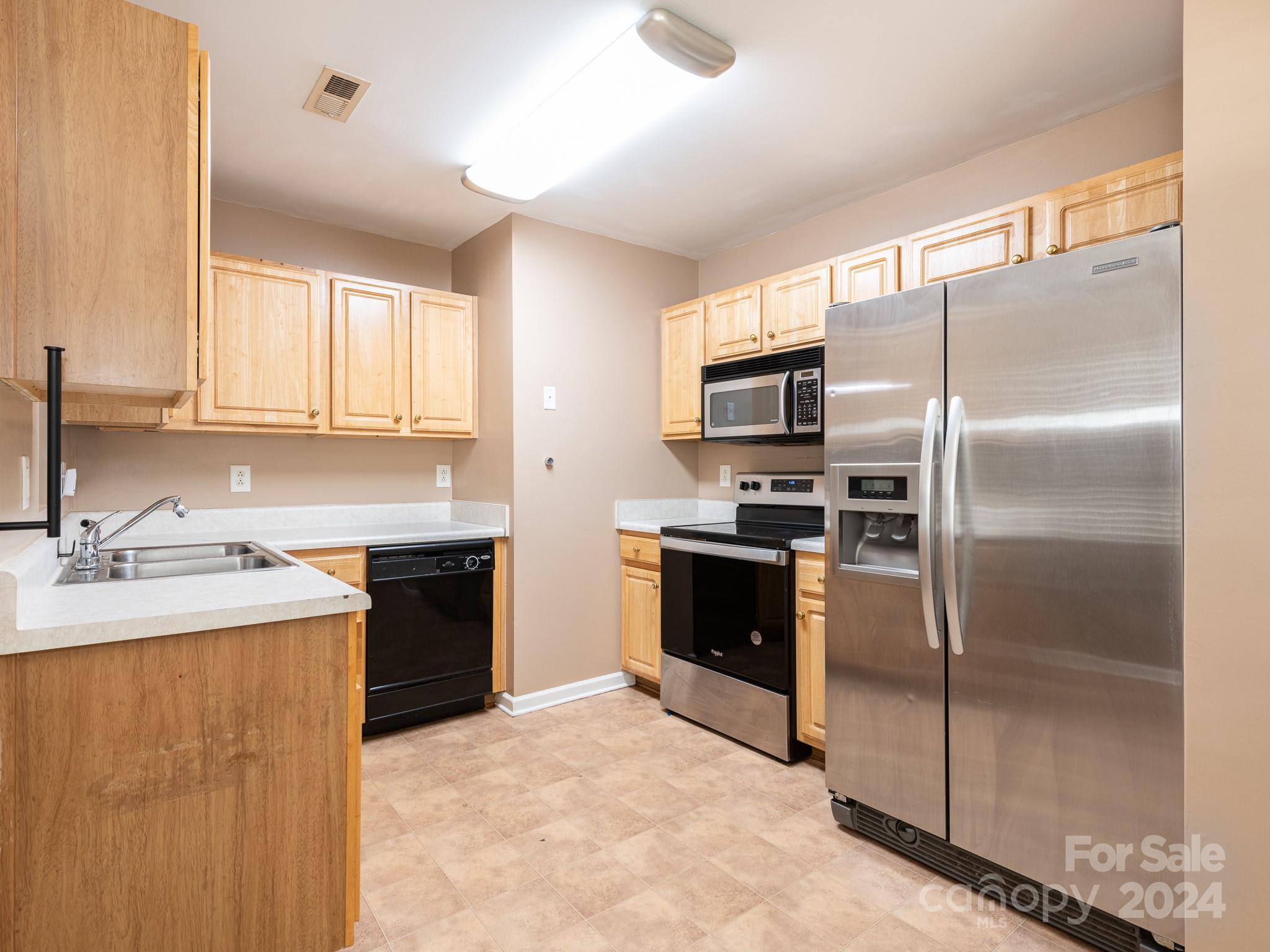 401 Funderburk Road Wingate, NC 28174 - Photo 32 of 36 a kitchen with a refrigerator sink and stainless steel appliances