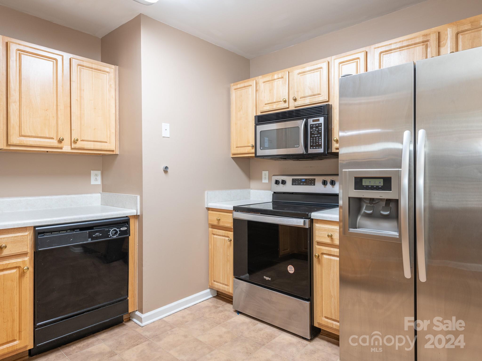 401 Funderburk Road Wingate, NC 28174 - Photo 33 of 36 a kitchen with granite countertop a stove microwave and refrigerator