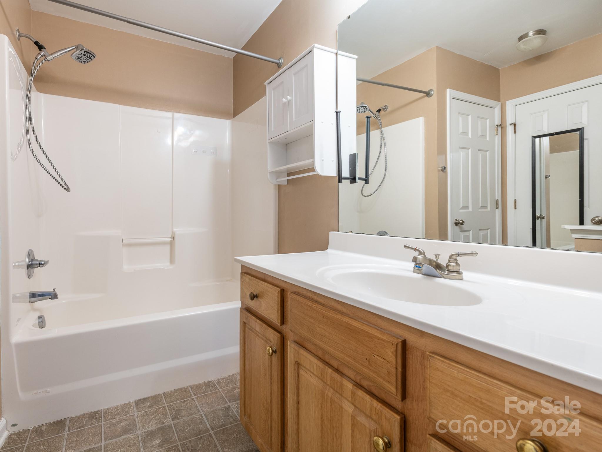 401 Funderburk Road Wingate, NC 28174 - Photo 6 of 36 a bathroom with a granite countertop sink a toilet and shower