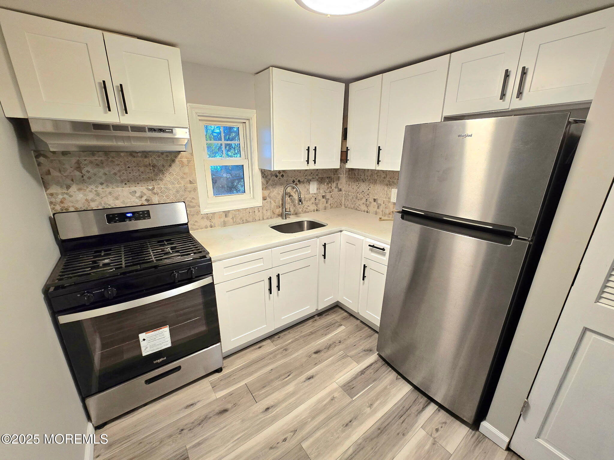 912 Sunset Avenue, Unit REAR Asbury Park, NJ 07712 - Photo 2 of 8 a kitchen with a stove refrigerator and a sink