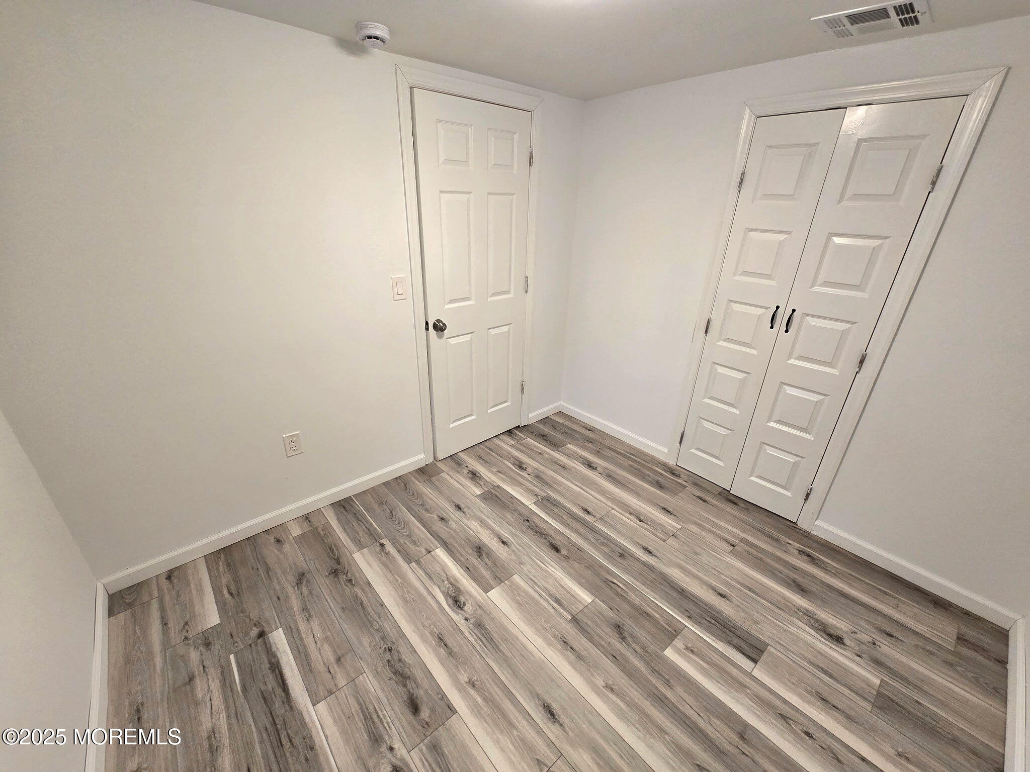 912 Sunset Avenue, Unit REAR Asbury Park, NJ 07712 - Photo 5 of 8 a view of empty room with wooden floor