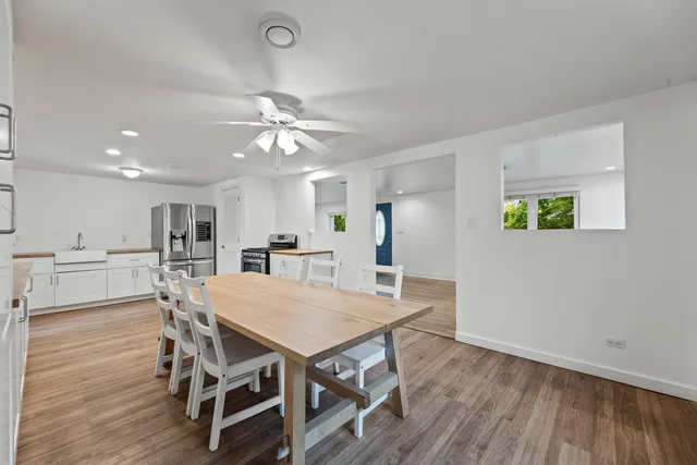 a view of a dining room with furniture and wooden floor