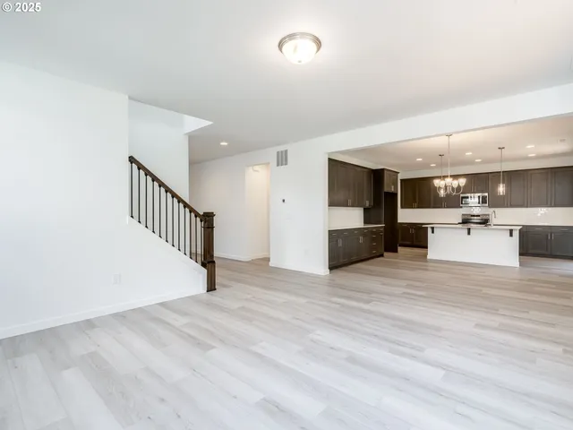 a view of a kitchen with a sink and a refrigerator