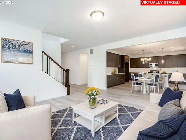 a living room with furniture and kitchen view