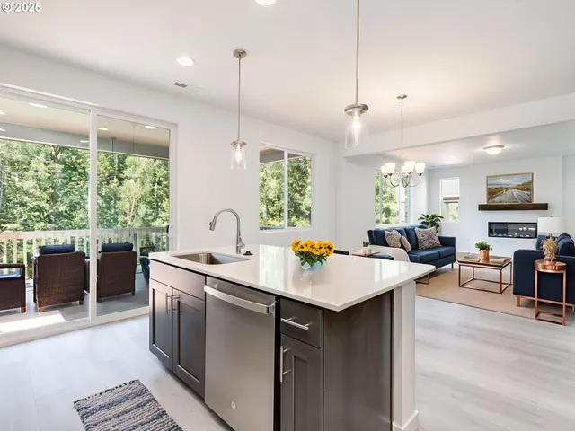 a open kitchen with stainless steel appliances granite countertop a sink a stove a dining table chairs and couches