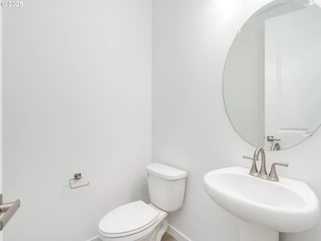 a bathroom with a sink a toilet and mirror