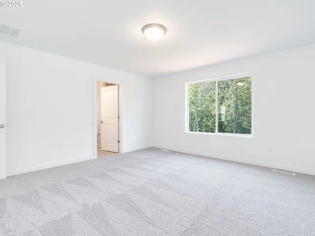 an empty room with windows and yard