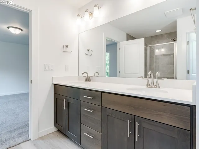 a bathroom with double sink and a mirror