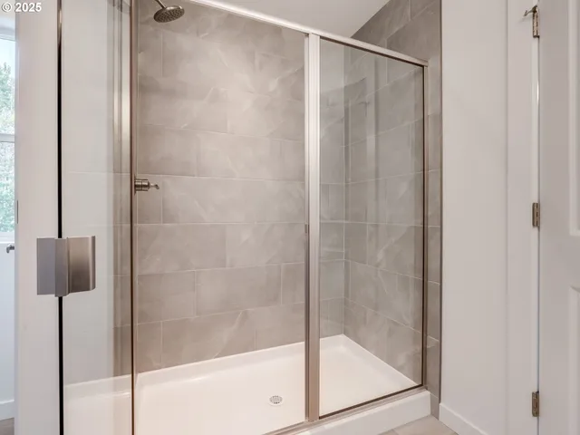 a bathroom with a glass shower door