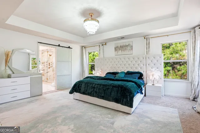 a spacious bedroom with a bed and a dresser