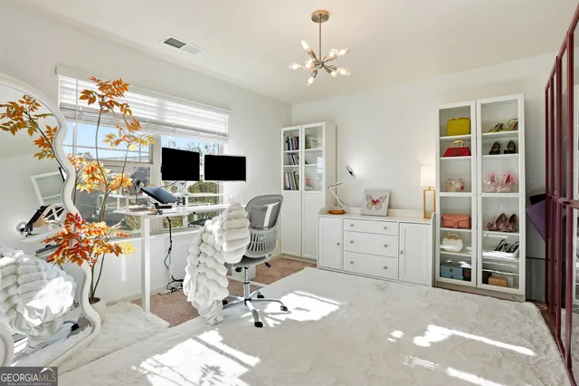 a living room with furniture a chandelier and a flat screen tv