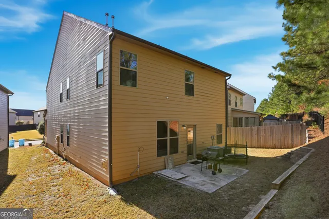 a backyard of a house with outdoor seating