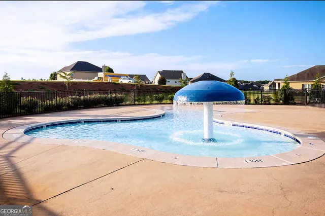 a front view of a house with garden and trees