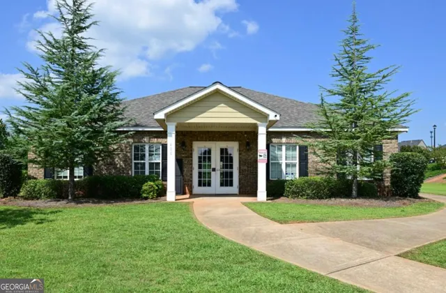 a view of a house with backyard and a slide