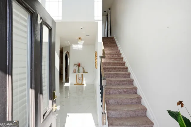 a view of a hallway with wooden floor and entryway
