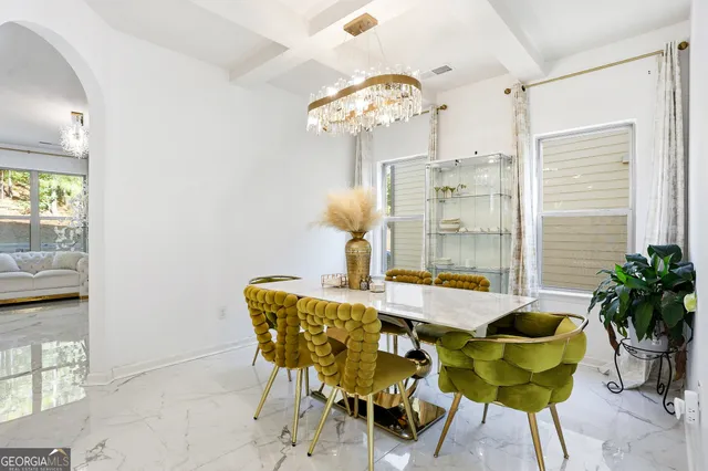 a view of a dining room with furniture and chandelier