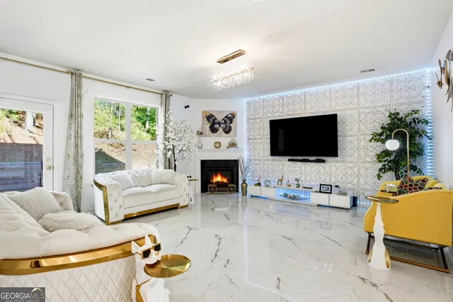 a living room with furniture fireplace and flat screen tv