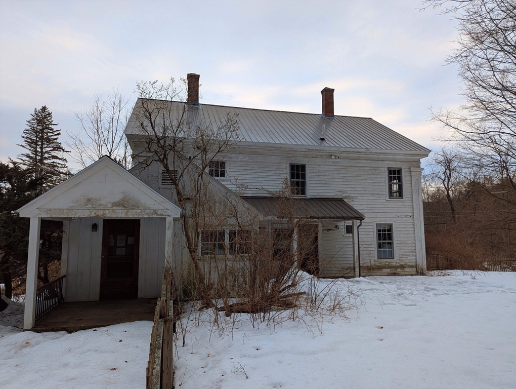 49 Enfield Road Pelham, MA 01002 - Photo 1 of 34 a front view of a house with a yard