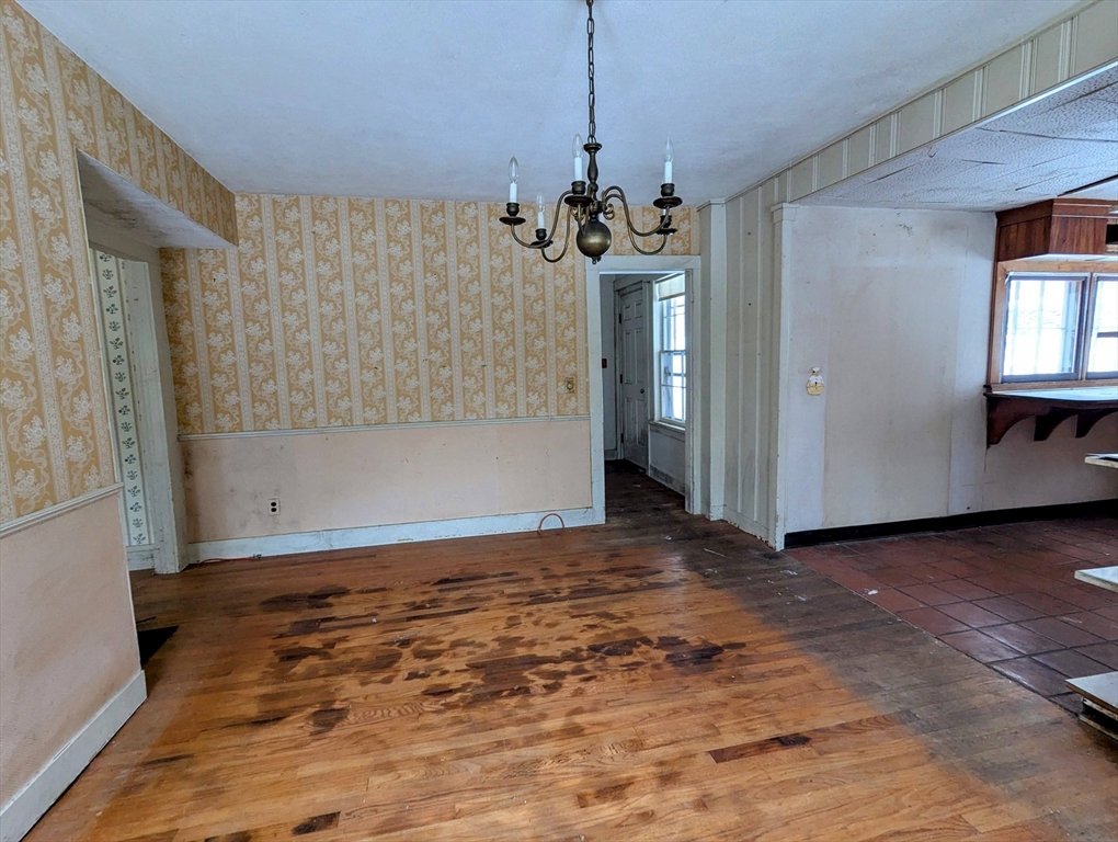 49 Enfield Road Pelham, MA 01002 - Photo 13 of 34 a view of a livingroom with a chandelier wooden floor and windows