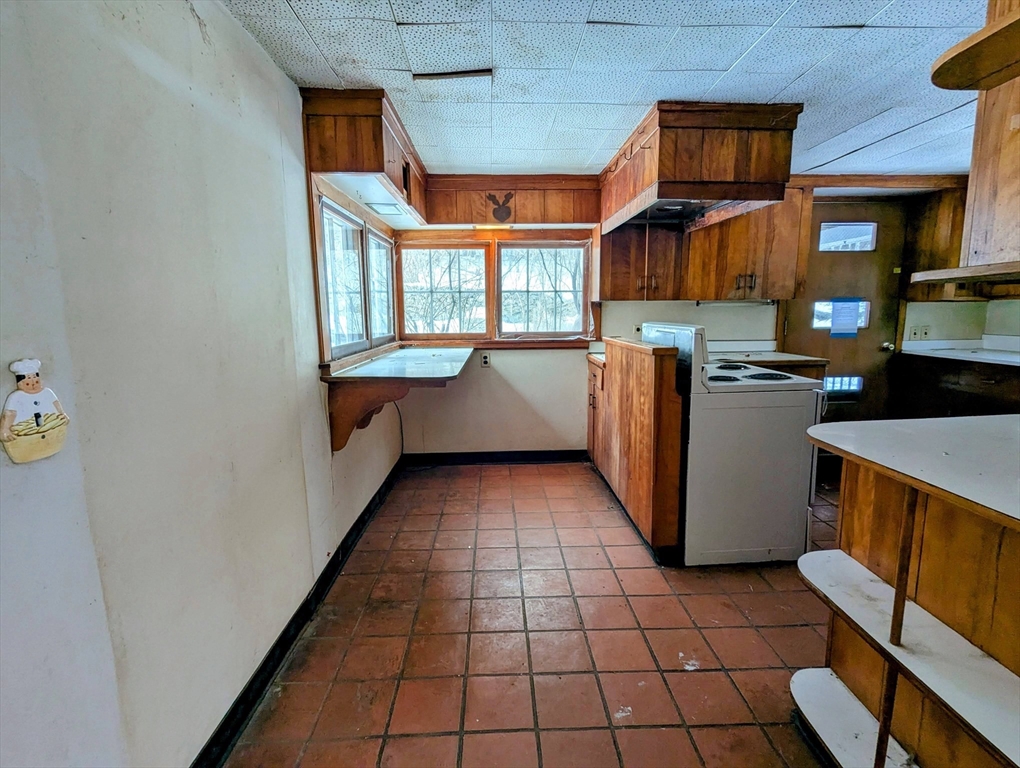 49 Enfield Road Pelham, MA 01002 - Photo 14 of 34 a kitchen with stainless steel appliances granite countertop a refrigerator and a stove
