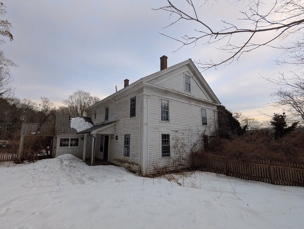 49 Enfield Road Pelham, MA 01002 - Photo 2 of 34 a view of a house with a snow in the background