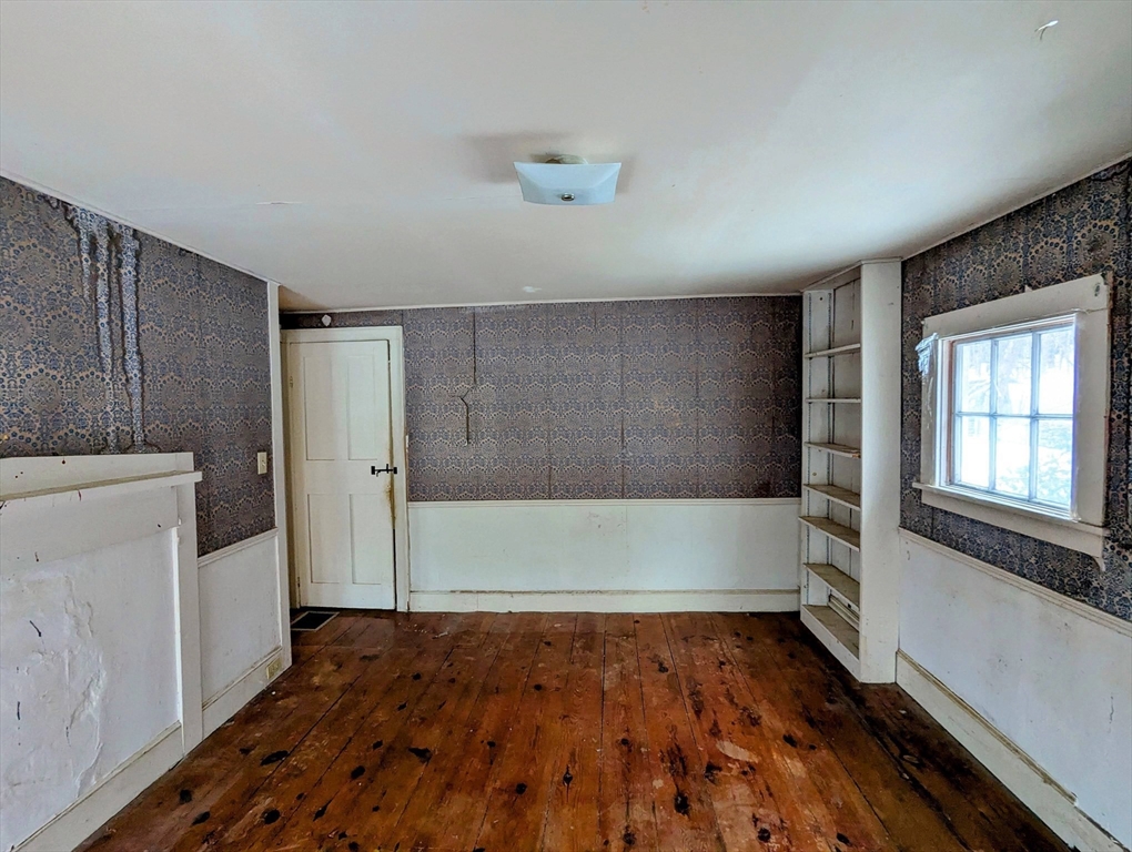 49 Enfield Road Pelham, MA 01002 - Photo 28 of 34 a view of an empty room with wooden floor and a window