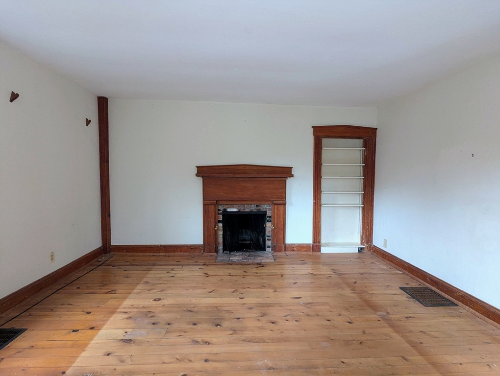 49 Enfield Road Pelham, MA 01002 - Photo 8 of 34 a view of an empty room with a fireplace