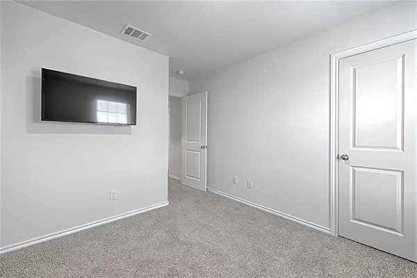 a view of an empty room with room and closet