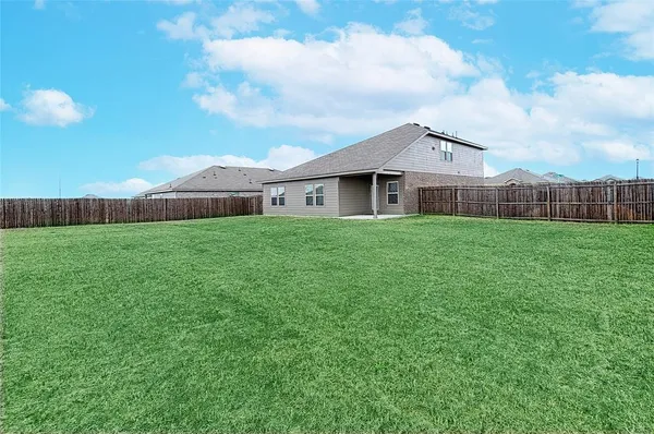a view of a house with a yard and sitting area