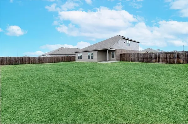 a aerial view of a house next to a yard