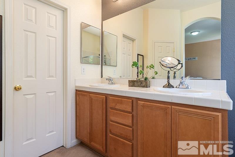 1445 Hagar Road Reno, NV 89506 - Photo 13 of 23 a bathroom with a double vanity sink and a mirror