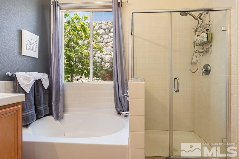 1445 Hagar Road Reno, NV 89506 - Photo 14 of 23 a bathroom with a shower and a tub