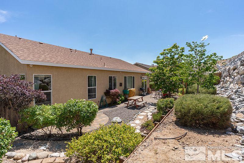 1445 Hagar Road Reno, NV 89506 - Photo 23 of 23 a view of a house with backyard sitting area and garden