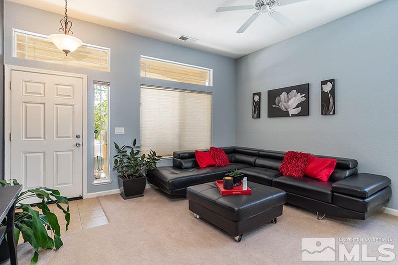 1445 Hagar Road Reno, NV 89506 - Photo 3 of 23 a living room with furniture and a chandelier
