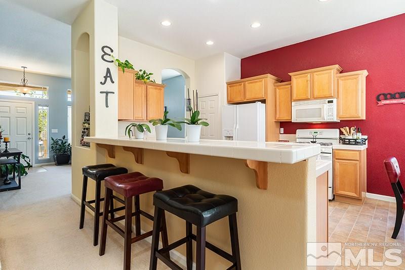 1445 Hagar Road Reno, NV 89506 - Photo 8 of 23 a kitchen with a table chairs sink and cabinets