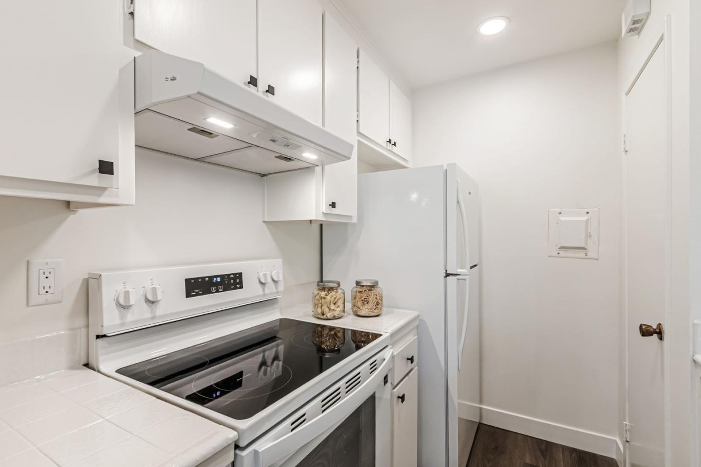 4643 Capay Drive, Unit 3 San Jose, CA 95118 - Photo 15 of 28 a kitchen with stainless steel appliances a stove a refrigerator and cabinets