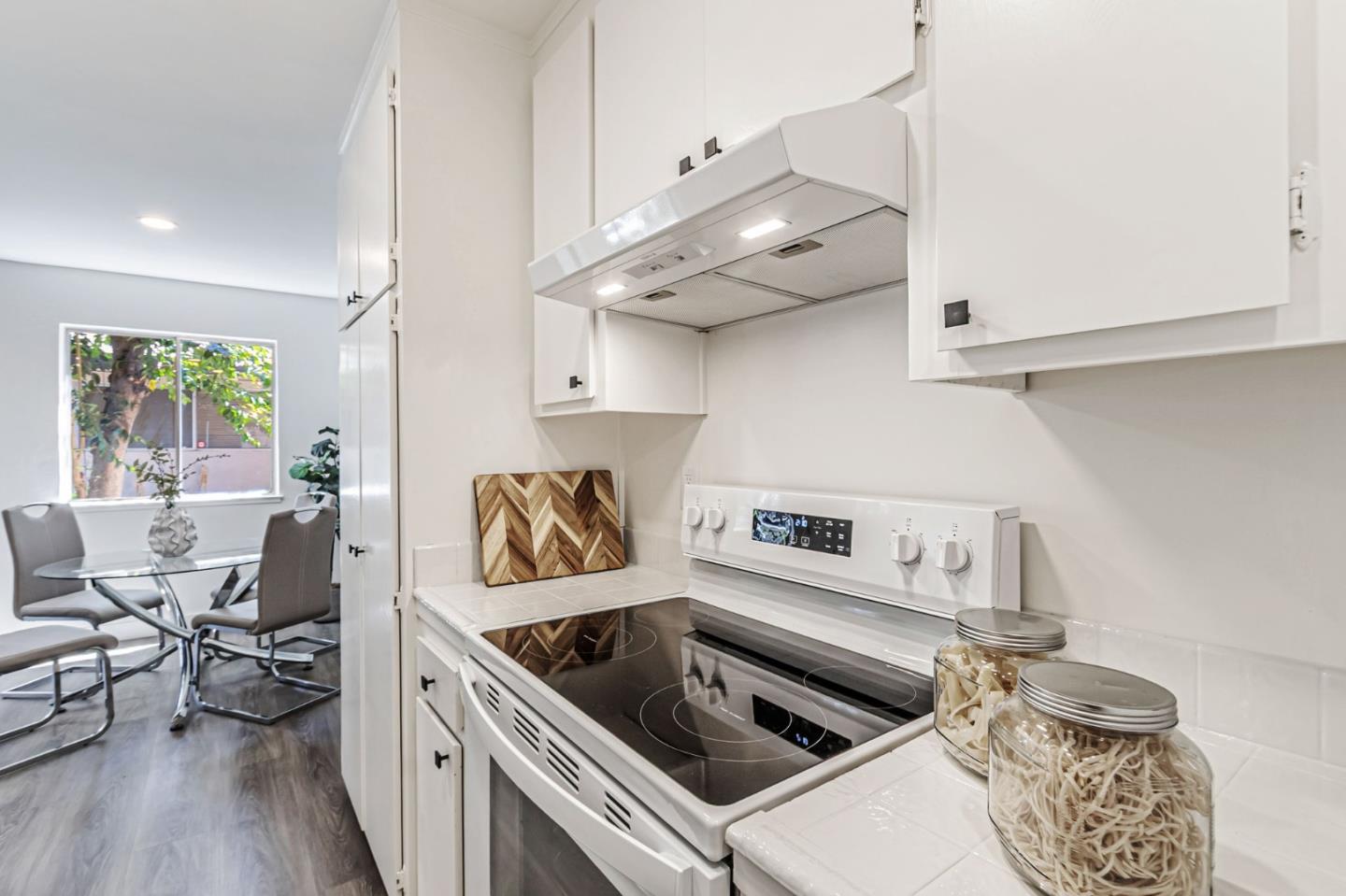 4643 Capay Drive, Unit 3 San Jose, CA 95118 - Photo 16 of 28 a kitchen with stainless steel appliances granite countertop a sink a stove and a wooden floors