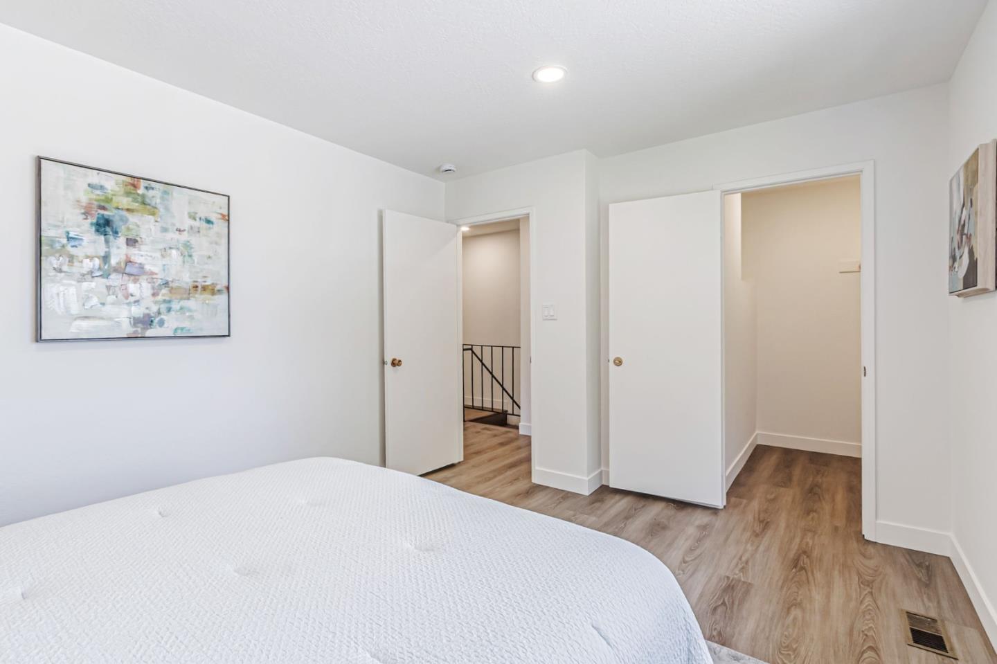 4643 Capay Drive, Unit 3 San Jose, CA 95118 - Photo 26 of 28 a bedroom with a bed and a painting on the wall