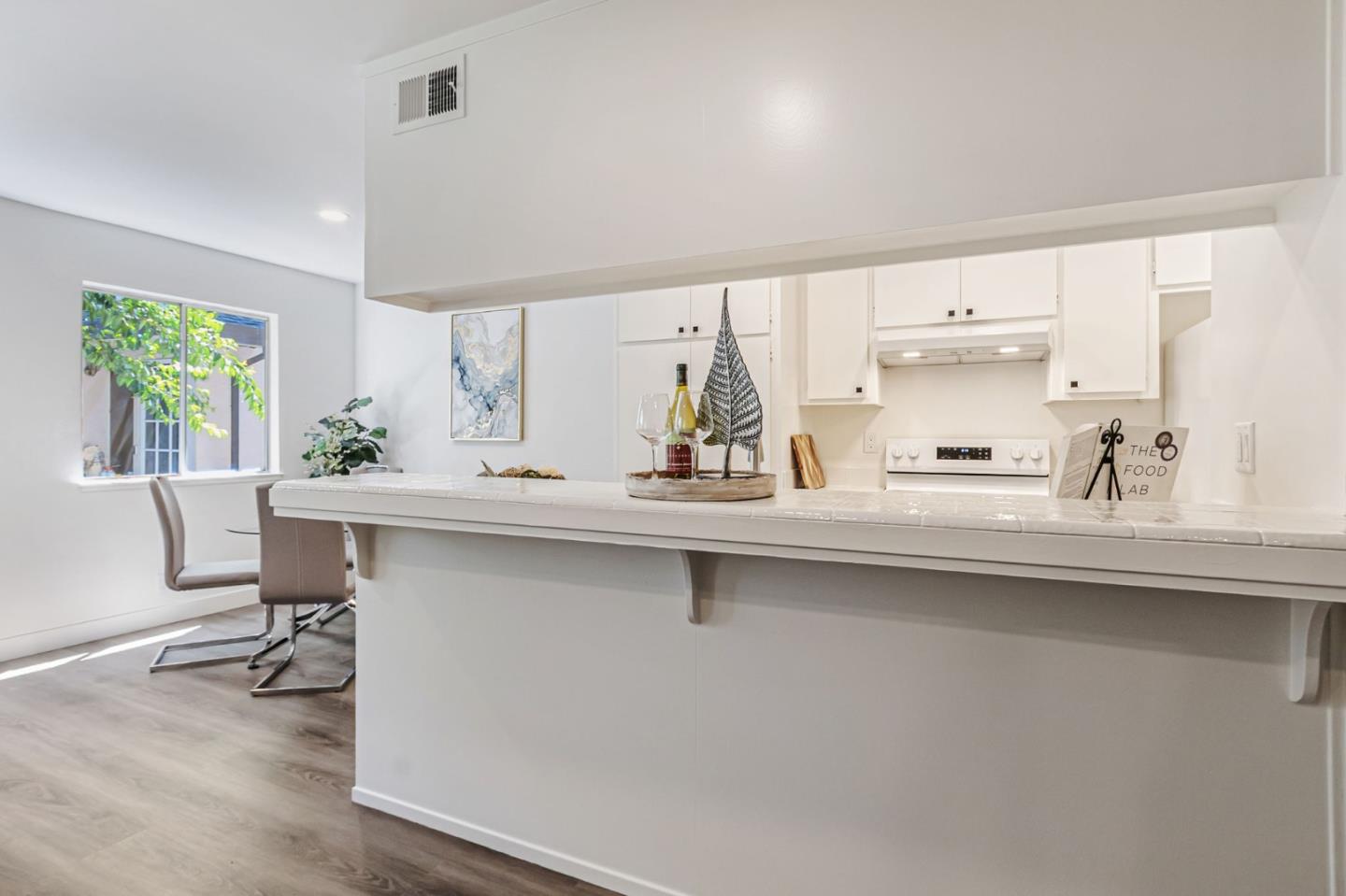 4643 Capay Drive, Unit 3 San Jose, CA 95118 - Photo 10 of 28 a kitchen with a sink a window and chairs