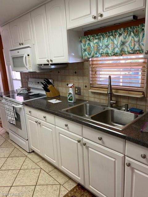 106 Audubon Road Naples, FL 34114 - Photo 13 of 27 a kitchen with stainless steel appliances granite countertop white cabinets and a sink