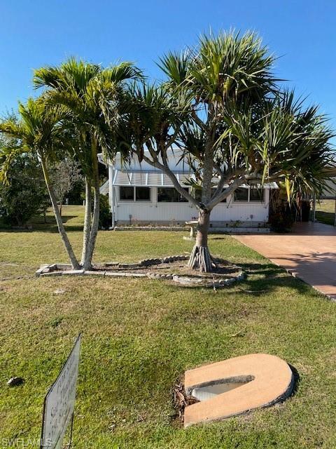 106 Audubon Road Naples, FL 34114 - Photo 2 of 27 a view of a yard with swimming pool