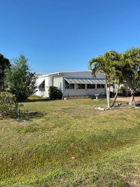 106 Audubon Road Naples, FL 34114 - Photo 3 of 27 a view of a house with a yard