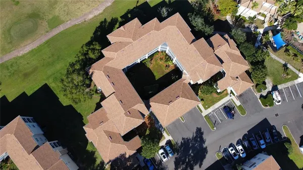 an aerial view of residential houses with outdoor space and parking
