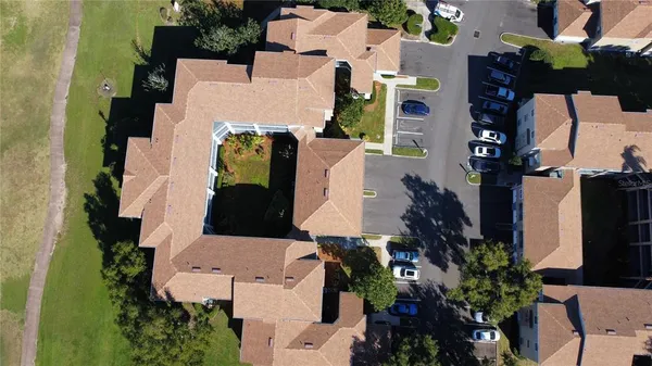 an aerial view of a house with a yard and swimming pool