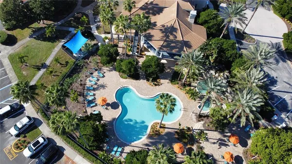 an aerial view of a house with a yard and swimming pool